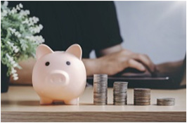 Piggy bank and pile of coins for savings Adapting Your Finances to Inflation