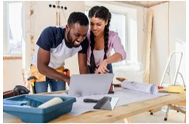 Renovations co-workers checking drawing on a laptop Home Renovations With the Best ROI